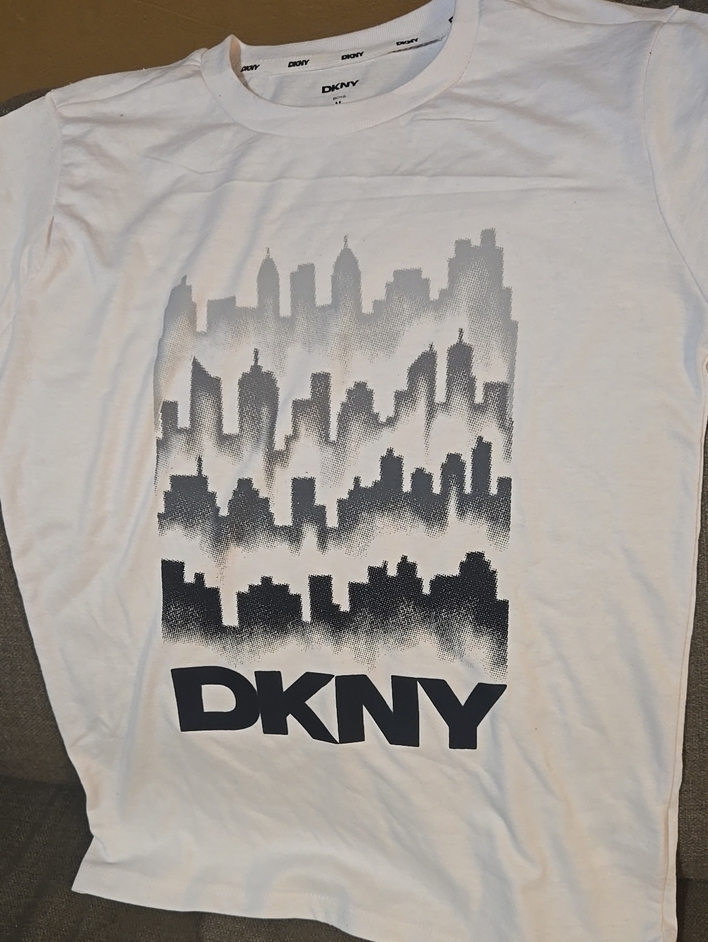 DKNY White Short‑Sleeve Tee with Black/Gray Skyline Graphic